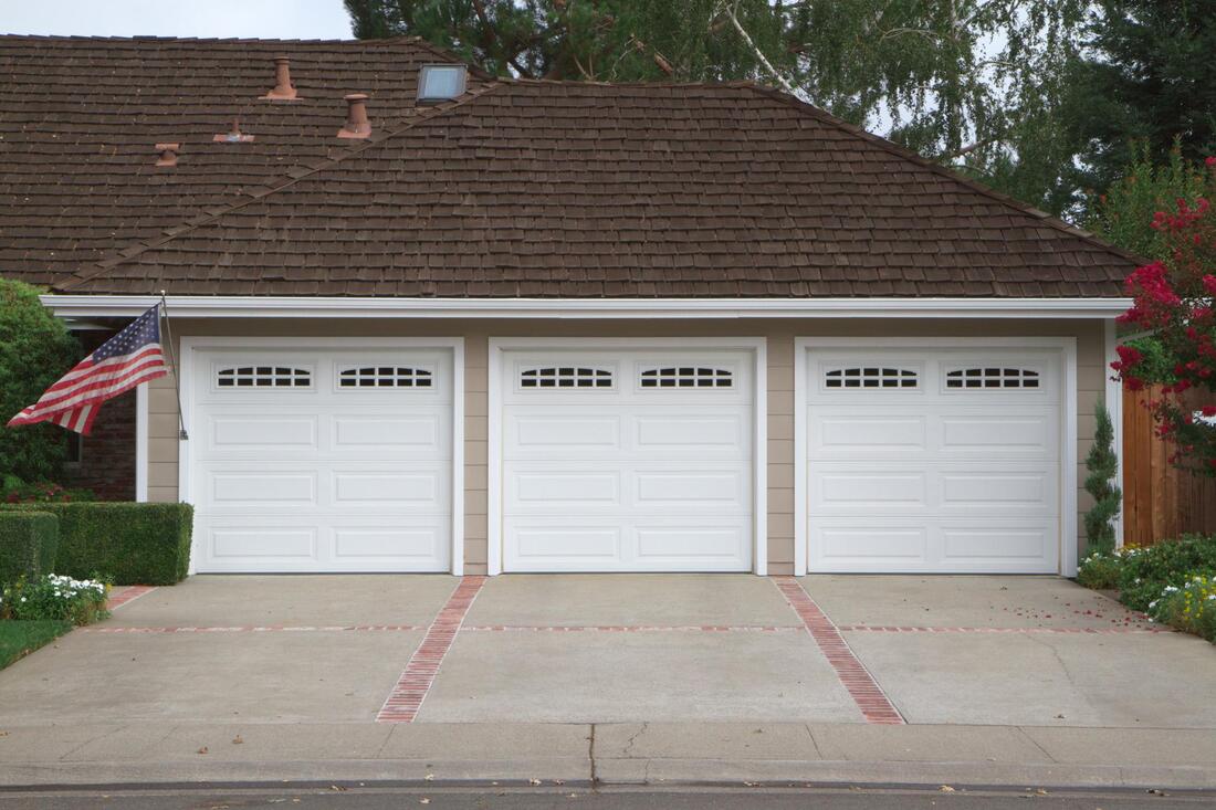 a view of garage with concrete driveway