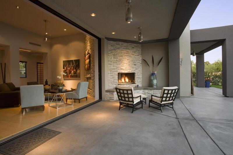 concrete patio with decorative fireplace feature